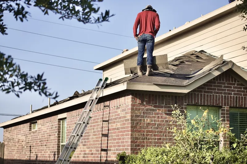 Professional roofer working on a residential roof in Fair Play
